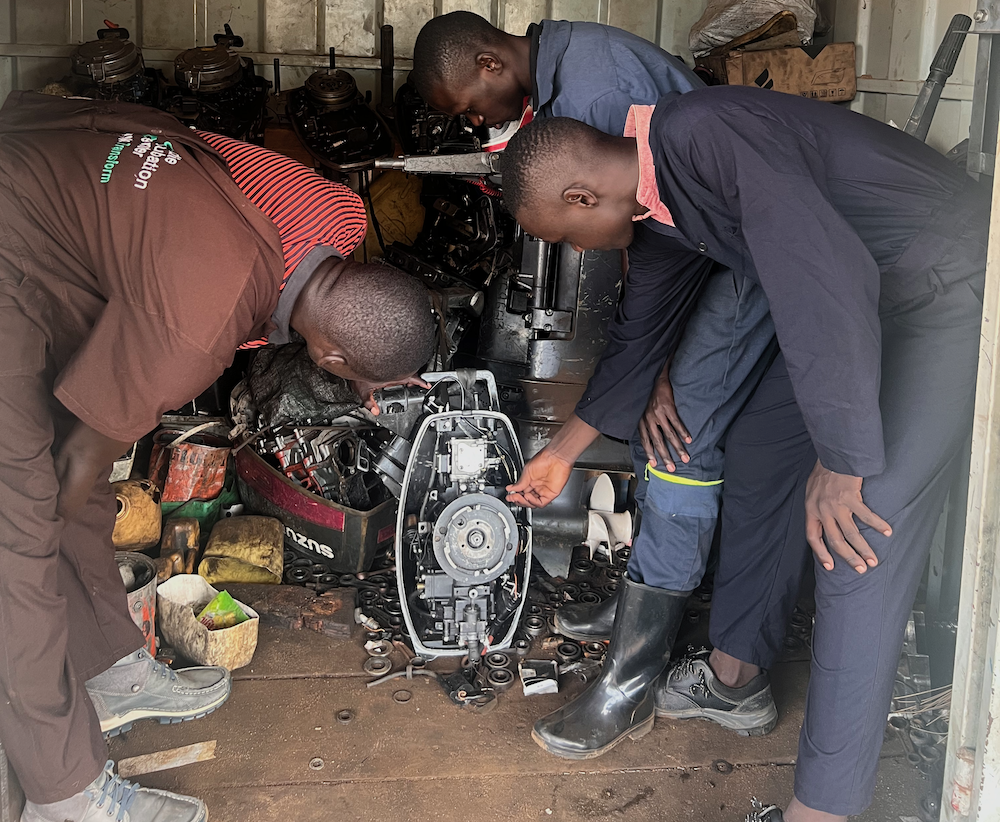 Students of Marine Vessel Construction, Engineering and Maintenance at Fisheries Training Institute studying an outboard engine